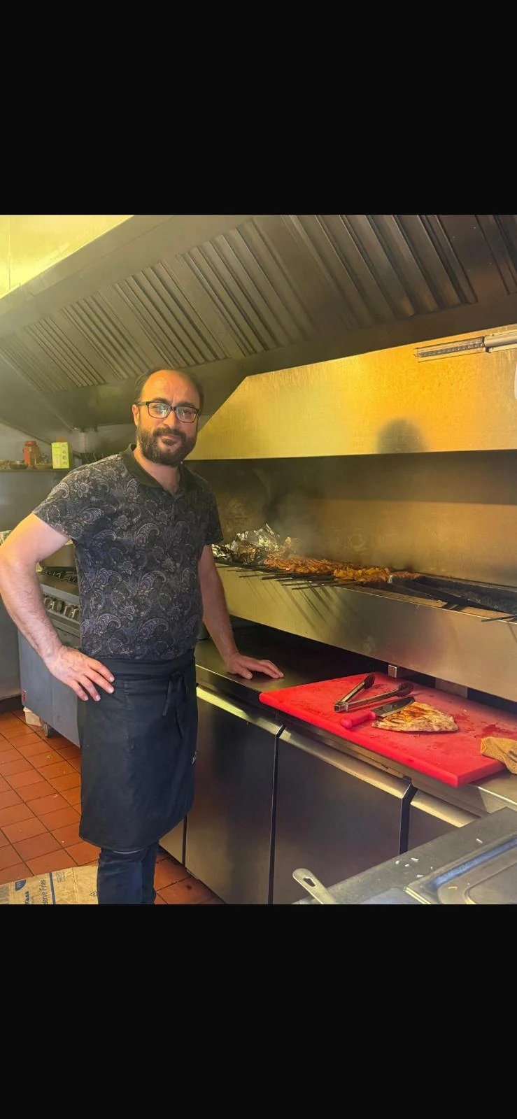 Chef Erkan beside the grill in the kitchen